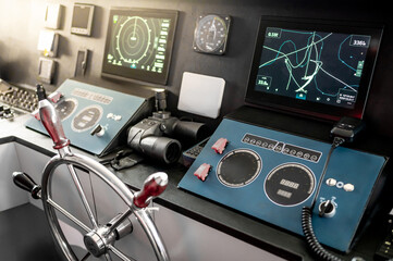 Digital dashboard with navigation monitor system, marine radar, VHF Radio and binoculars in ship captain bridge or boat control room. Wheelhouse steering console on nautical vessel. Boating technology © zephyr_p
