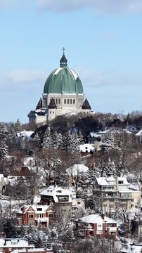Saint Josephs Oratory dome above snowy Westmount and Montreal neighborhood on Mount Royal hill in winter, Quebec, Canada. g.