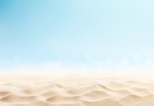 Seascape with yellow beach sand and soft blue sky. Product presentation backdrop.
