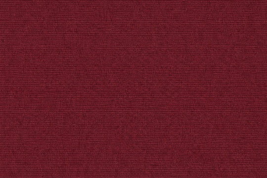 Maroon corduroy fabric texture with soft ribbed surface and rich woven textile detail. Ideal for upholstery visuals, fashion backgrounds, and vintage interior design.
