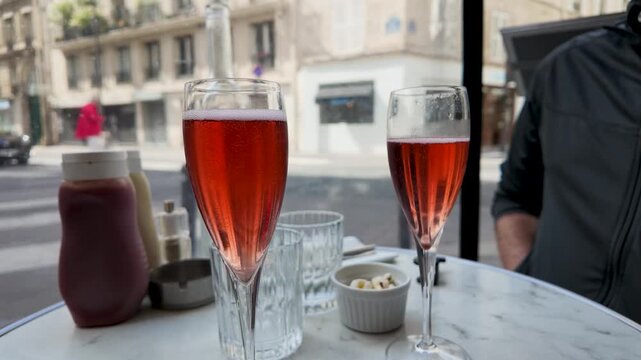 Two Red Cocktails on a Marble Table at a Paris Sidewalk Cafe