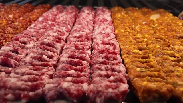 Grilling meat skewers at local market in summer