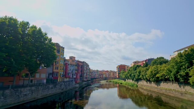 Colorful houses reflecting on the Onyar river in Girona