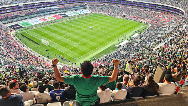 Mexico City, Mexico - Apr 19, 2026: Soccer fans wearing Mexico national team jerseys get excited and celebrate their team at the stadium