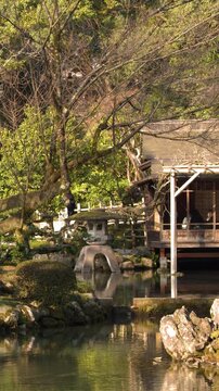 Traditional Teahouse and Stone Lantern at Kenrokuen Garden in Kanazawa Japan