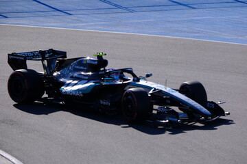 Obraz premium May 24, 2026, Montreal, Canada, Mercedes F1 car racing through Circuit Gilles Villeneuve corner. g.