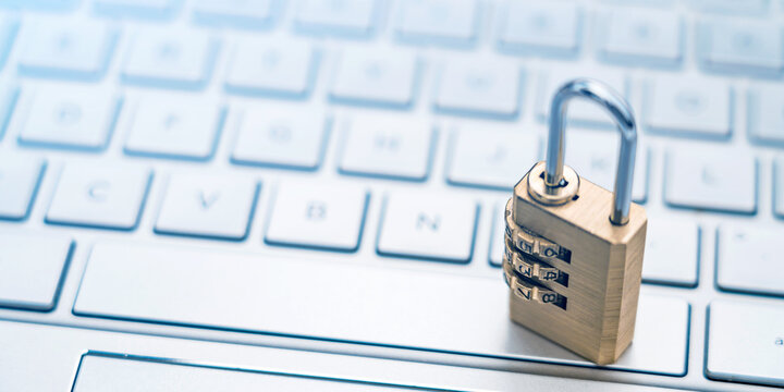 The lock is placed on the computer keyboard to symbolize information security and data interconnection