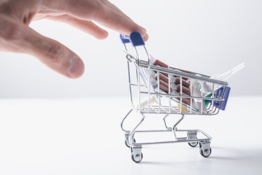 Shopping cart with wooden cubes on a white background. Online shopping concept.