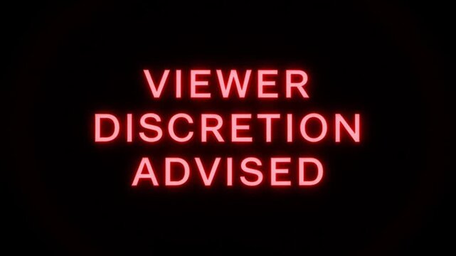 Red neon viewer discretion advised warning text glowing on a black background