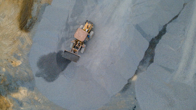 Wheel Dozer Carrying Crushed Stone to Outdoor Stockpile Area, Mining Site from Above