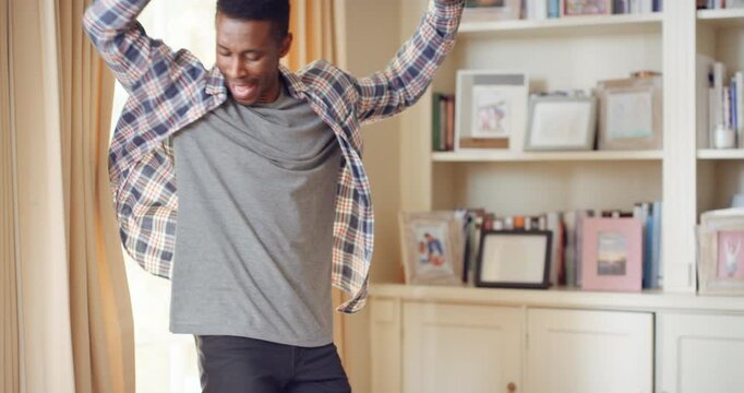 Black man, spinning and dancing for fun at house with energy, playful rhythm and practice session. Male person, dancer and twirling with movement, choreography and hiphop for weekend entertainment