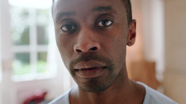Calm, serious and face of man in home with peaceful morning, weekend break or solitude on day off. Chill, black person or quiet afternoon in living room for me time, passive emotion or relax in house