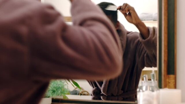 Mirror, dance and black man in bathroom with comb, morning routine or grooming to start day with wink. Home, reflection and person with energy, haircare and maintenance for beauty with self care