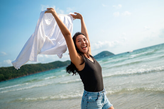 Trendy young traveler enjoying sunny weather and coastal breeze on a luxury tropical island resort