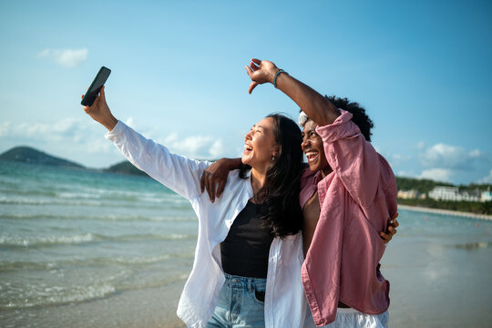 Carefree couple enjoying a tropical beach vacation, laughing making unforgettable memories together
