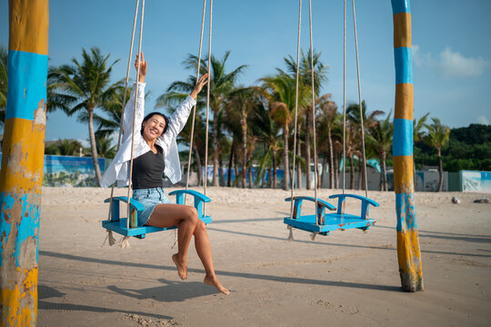 Trendy young traveler enjoying sunny weather and coastal breeze on a luxury tropical island resort