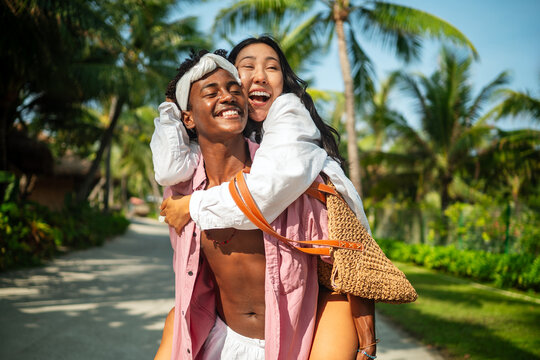 Happy interracial couple embracing and sharing a romantic moment during a tropical island getaway