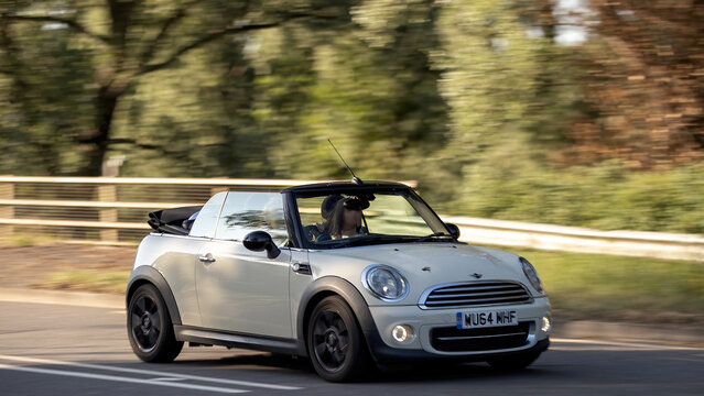 Milton Keynes,Bucks,UK - May 27th: 2014 white Mini Cooper car driving on a British road