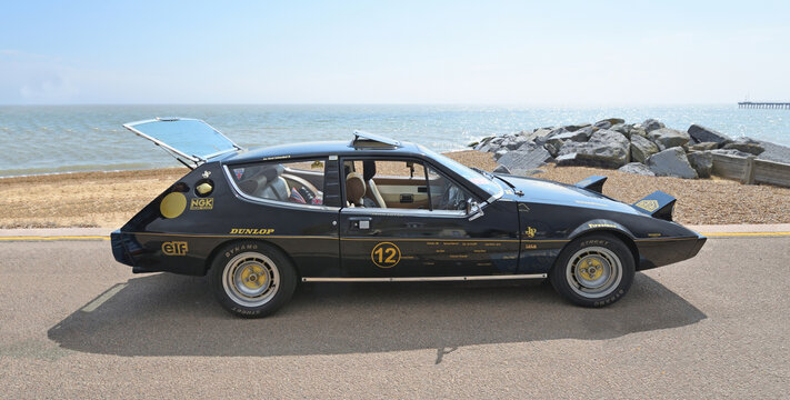 Classic Black Lotus Elite  John Player Special on seafront promenade beach and sea in background