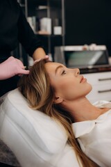 Naklejka premium Woman receiving scalp mesotherapy treatment for hair growth