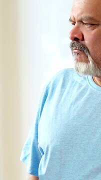 Indian Asian male doctor walks with a senior patient in a hospital passage, explaining the case report and procedure. He provides expert guidance, ensuring clarity, confidence, and quality healthcare