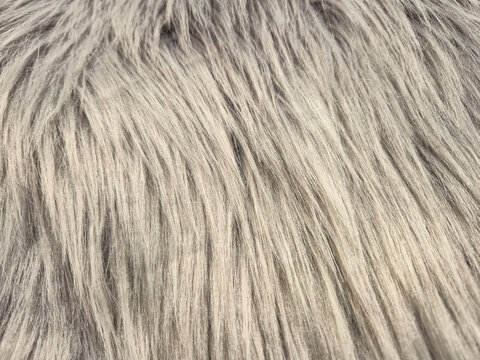 Close-up texture of soft, fluffy grey faux fur with a luxurious feel