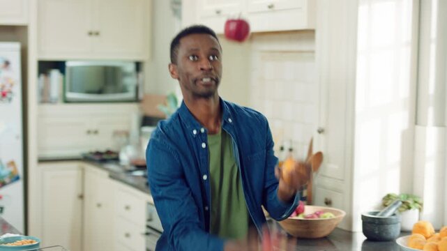 Dancing, juggle and black man in kitchen with energy for performance, humor and expression in home. Happy, movement and male person with fruit for hobby, entertainment and weekend fun in apartment