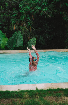 Child in swimming pool, happy summer lifestyle with water play, sunshine, relaxation and bright family vacation energy in a clean outdoor setting, soft natural light, realistic detail, clean