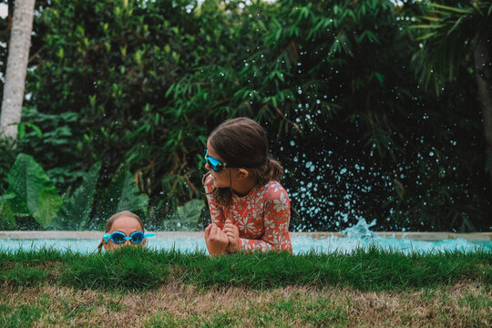 Child in swimming pool, happy summer lifestyle with water play, sunshine, relaxation and bright family vacation energy in a clean outdoor setting, soft natural light, realistic detail, clean