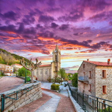 Amazing evening cityscape with Parish Church of the Assumption in Zonza village with typical stone houses