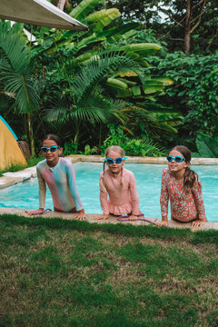 Child in swimming pool, happy summer lifestyle with water play, sunshine, relaxation and bright family vacation energy in a clean outdoor setting, soft natural light, realistic detail, clean