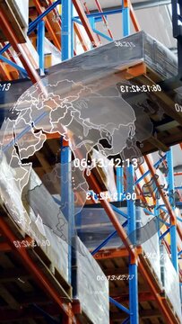 Vertical video: Camera tilting showing spinning globe over pallet load, forklift nearing for pickup