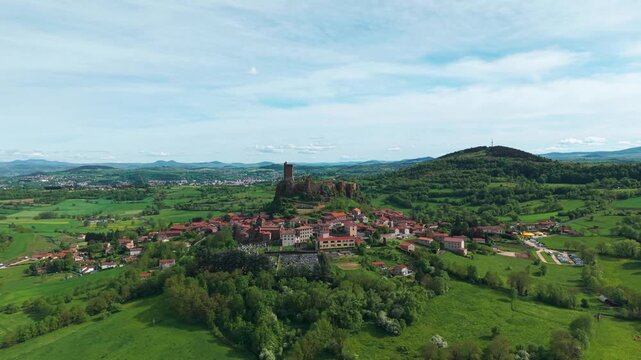 Aerial shot going forward to the Polignac Fortress on a sunny day near le Puy en Velay in Haute Loire departement in Auvergne Rhone Alpes region, France