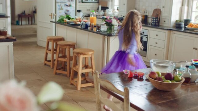 Fun, dancing and child with spin in kitchen for ballet practice, creative energy or development. Girl kid, ballerina and movement with tutu in home for performance rehearsal, learning steps or growth