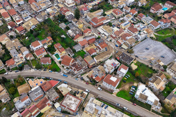 Fototapeta premium High Angle Aerial Drone View of Kassiopi Town Streets Parking and Red Rooftops on Corfu Island Greece