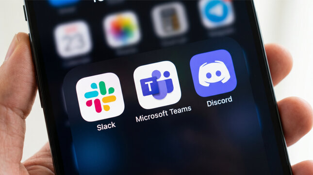 Slack, Microsoft Teams, Discord mobile icons app on a screen smartphone iPhone closeup. Slack, Microsoft Teams, Discord are popular platforms for business communication and community chat.