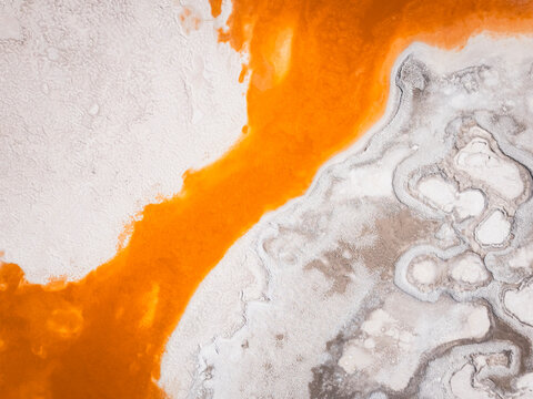 Orange river flows through white salt flats