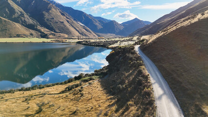 Naklejka na ściany i meble Aerial View of a Winding Road Beside Lake Moke in Queenstown