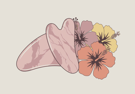 Two pink gua sha tools are arranged with three colorful hibiscus flowers, suggesting beauty and wellness.