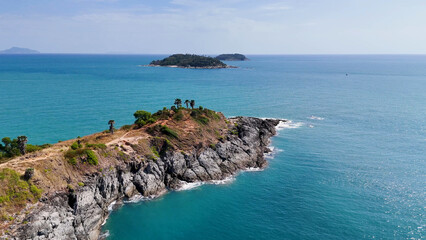 Aerial View of Promthep Cape Cliffs and Turquoise Ocean in Phuket © blueringmedia