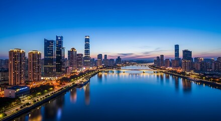 Fototapeta premium A vibrant city skyline with illuminated skyscrapers and bridges reflects beautifully in a tranquil river during twilight, showcasing urban development and nighttime beauty.