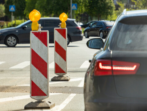 Traffic jam at a construction site with road barriers and cars
