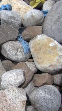 Discover the mystic Oboo, a sacred stone cairn adorned with vibrant blue and yellow khadag, nestled in the majestic mountains near Lake Khuvsgul, Mongolia. An ancient spiritual beacon.