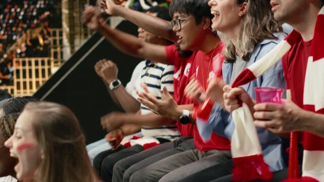 Red team soccer fans reacting to close call in stadium stands, hands on head, scarves and anxious crowd during live football match, anxious supporters show tension and suspense, inclusive fans.