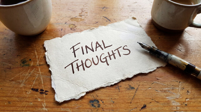 Final thoughts written on handmade paper with a vintage fountain pen, coffee break on a wooden desk