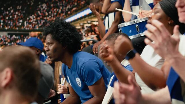 Disappointed soccer supporters reacting to missed chance during tense football match, filled with hope and tension in the stadium stands, worried fans speechless and holding breath, last chance.