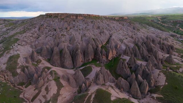 aerial drone of the ancient hand-carved Selime Cathedral rock monastery. Spectacular historic troglodyte architecture and volcanic mountain landscape in Cappadocia, Turkey