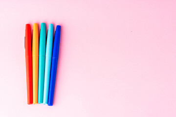 Fototapeta premium coloured rainbow pens on a pink background