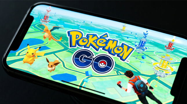 Pokemon GO mobile logo app on a screen smartphone iPhone. Pokemon GO is a popular augmented reality (AR) mobile game developed by Niantic for iOS and Android devices, featuring Pikachu and Eevee.