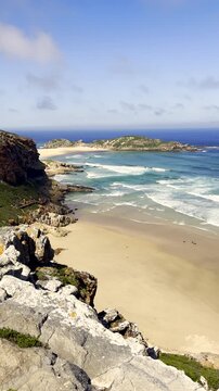 Vertical. View over scenic beach and Robberg Nature Reserve coastline